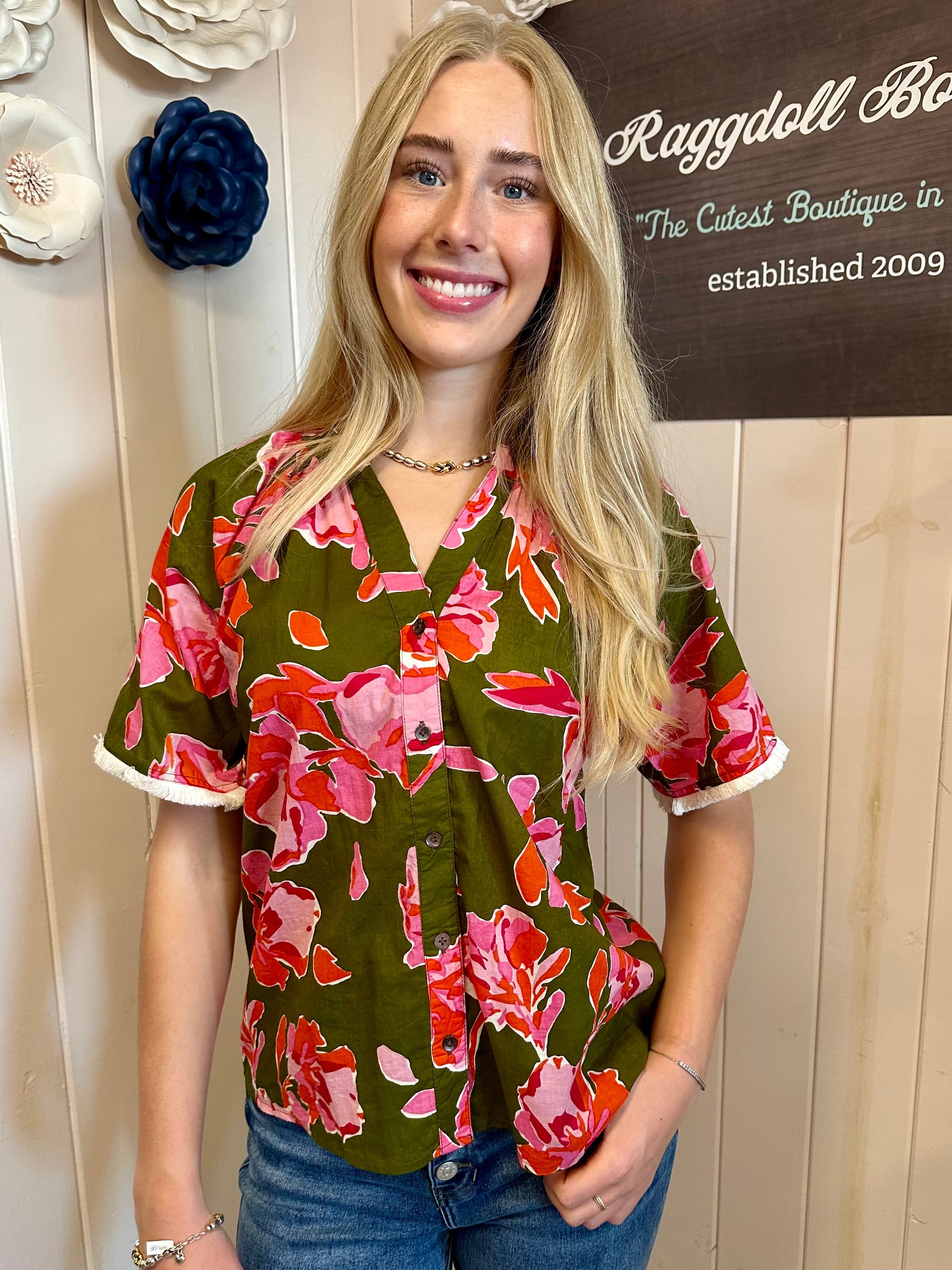 Woman in colorful floral top, perfect for coastal boutique clothing or beach dresses from Port Aransas boutique.