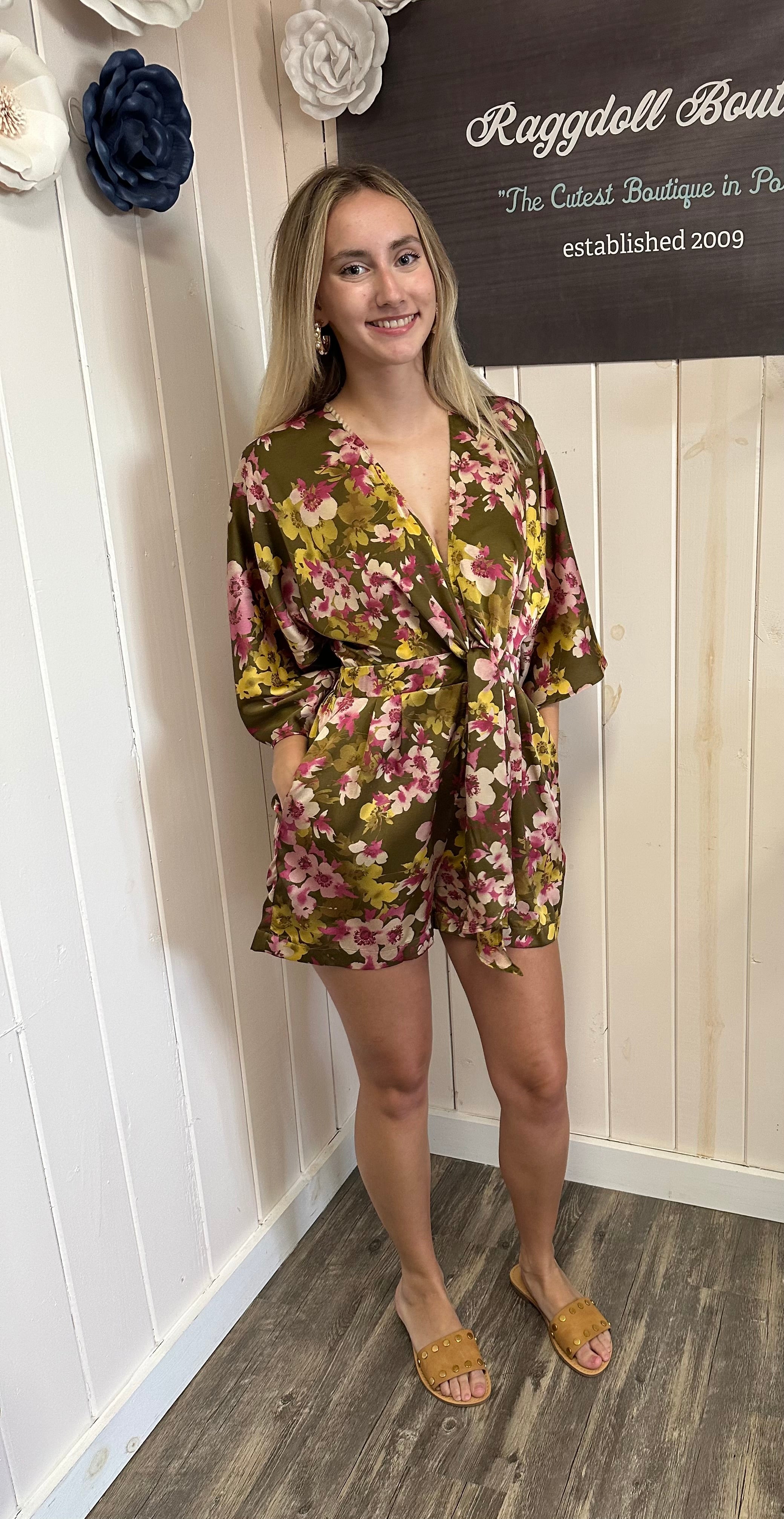Light blue denim romper with buttons, perfect for stylish summer beach looks. Part of our Port Aransas boutique collection.