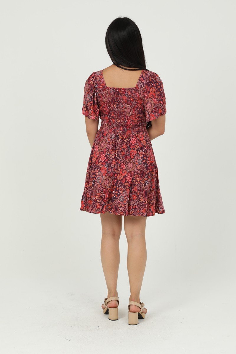 Back view of the berry-colored Arabella Dress, featuring a floral print, ideal for stylish women’s fashion from a coastal boutique.