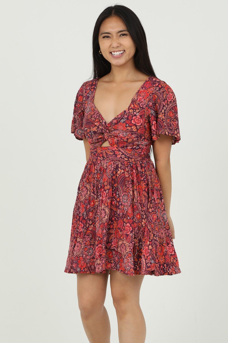 Berry floral V-neck dress with twist front, perfect for beach outings and coastal boutique fashion.