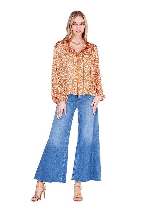 Tara Top with vibrant floral design, paired with wide-legged jeans, ideal for coastal boutique clothing and beach dresses.