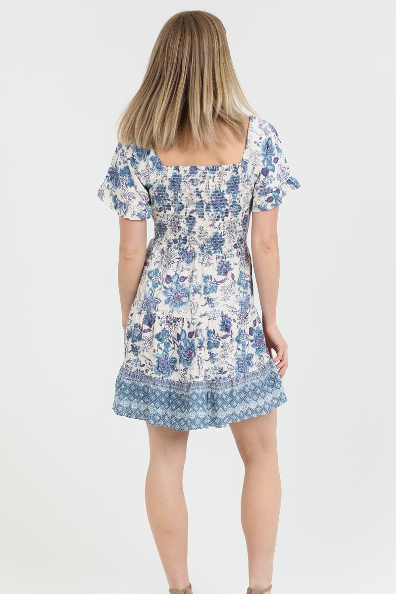 Back view of a floral blue and ivory summer dress, perfect for coastal boutique clothing and tropical vacation dresses.