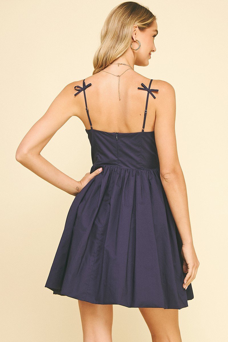 Navy sleeveless Tommi Dress with ribbon detail, ideal for coastal boutique clothing and beach dresses.