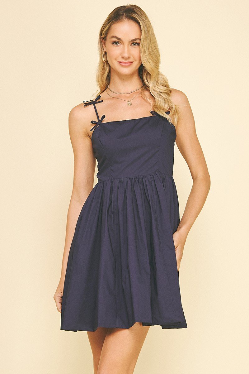 Navy sleeveless dress with ribbon detail, perfect for coastal boutique clothing and tropical vacation dresses.