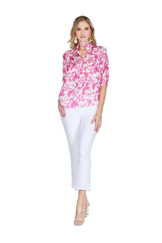 Stylish magenta hibiscus top featured with white pants; perfect for coastal boutique clothing and tropical vacation dresses.