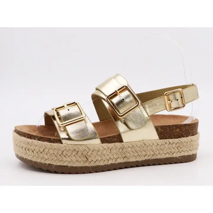Gold metallic double buckle espadrille sandals with cork sole, perfect for coastal boutique clothing and summer styles.