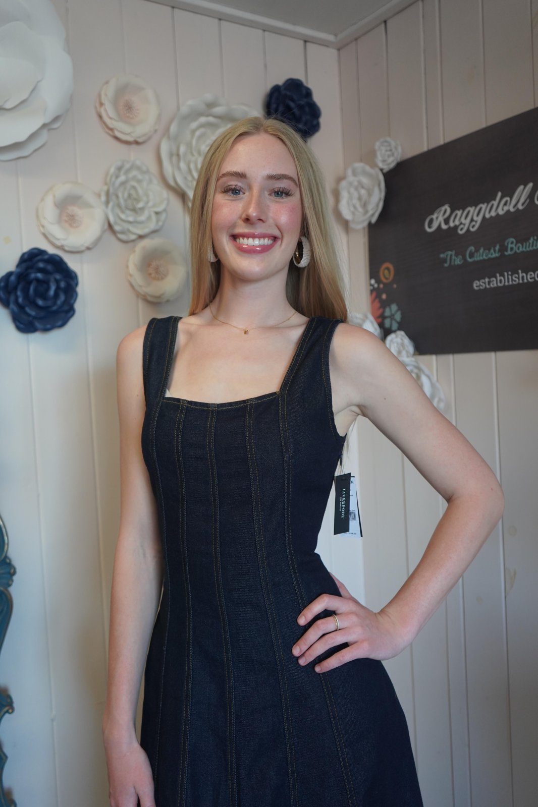 Model showcasing sleeveless smocked back indigo midi dress from coastal boutique, perfect for summer occasions.