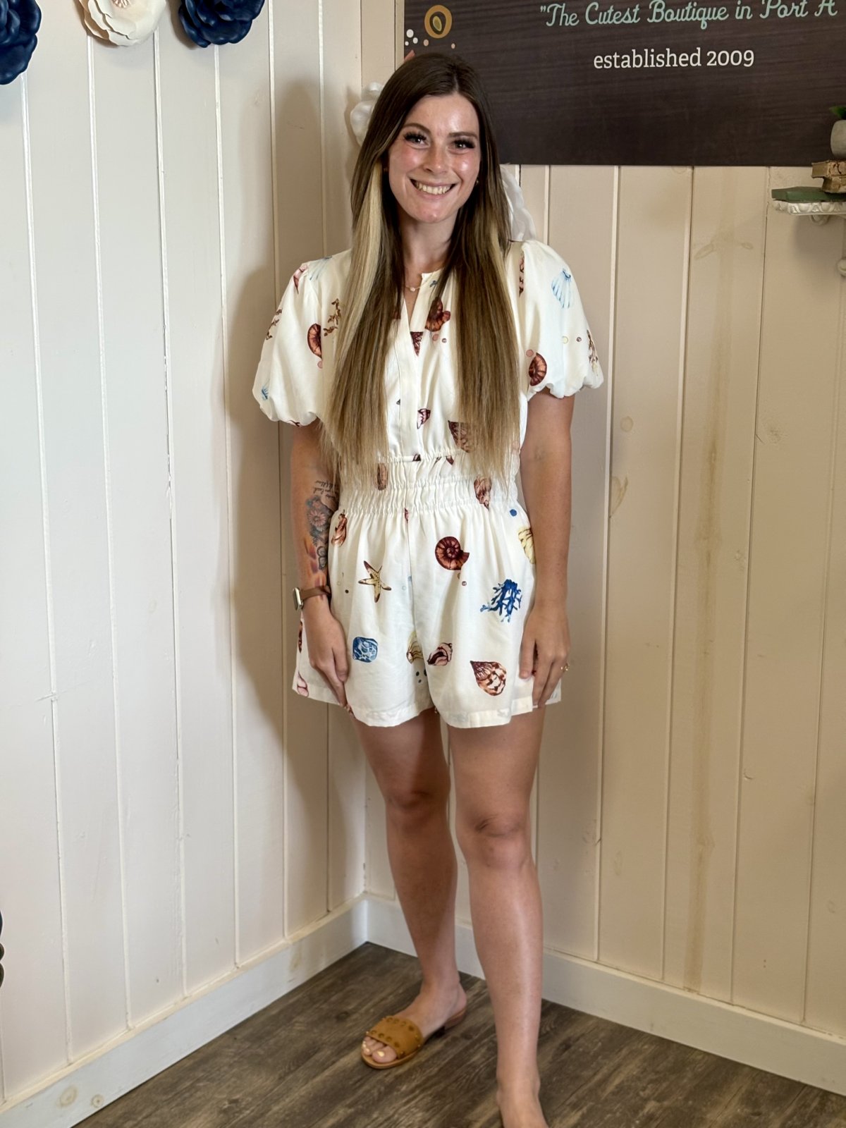 Off-White Shell Print Romper with puff sleeves, styled for coastal boutique clothing; perfect for tropical vacation dresses.