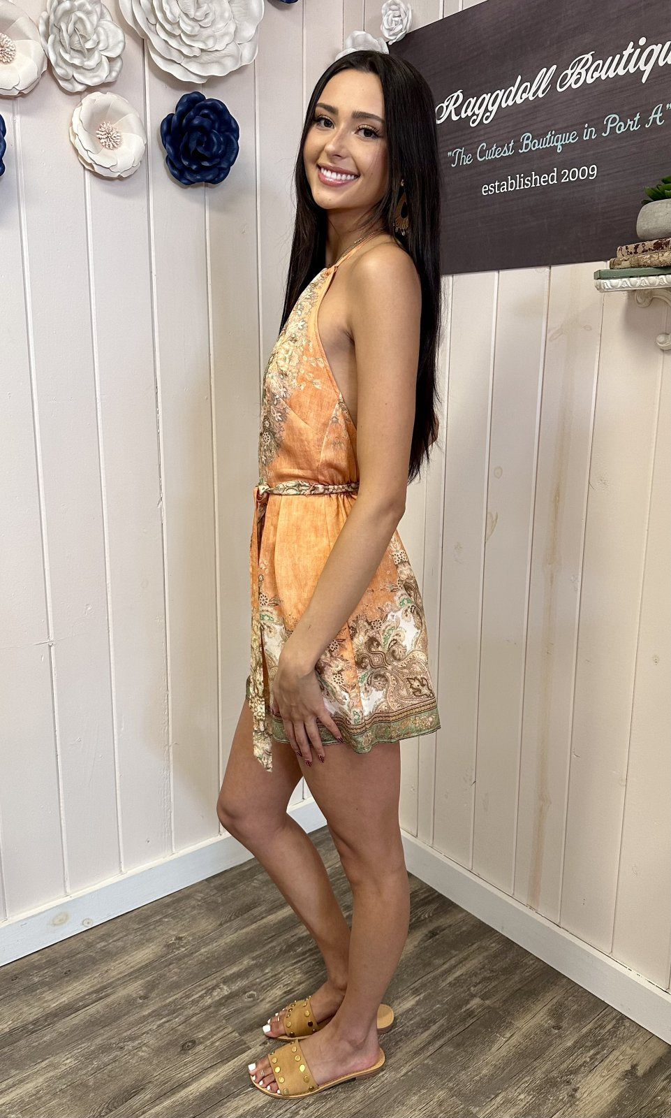 Light apricot halter romper from coastal boutique clothing, perfect for summer parties and tropical vacations.