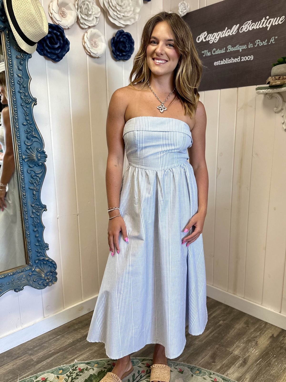 Chic blue and white tube midi dress from a coastal boutique, perfect for summer outings and tropical vacations.