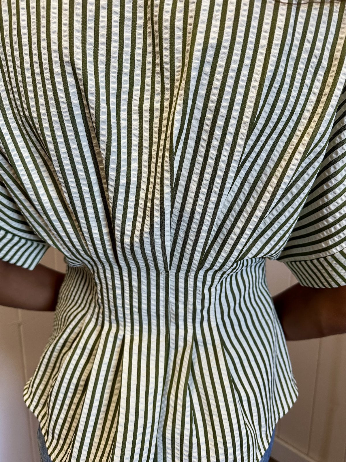 Back view of the Kendra Top from Raggdoll Boutique with cream and olive green stripes, showcasing its tailored yet relaxed fit.