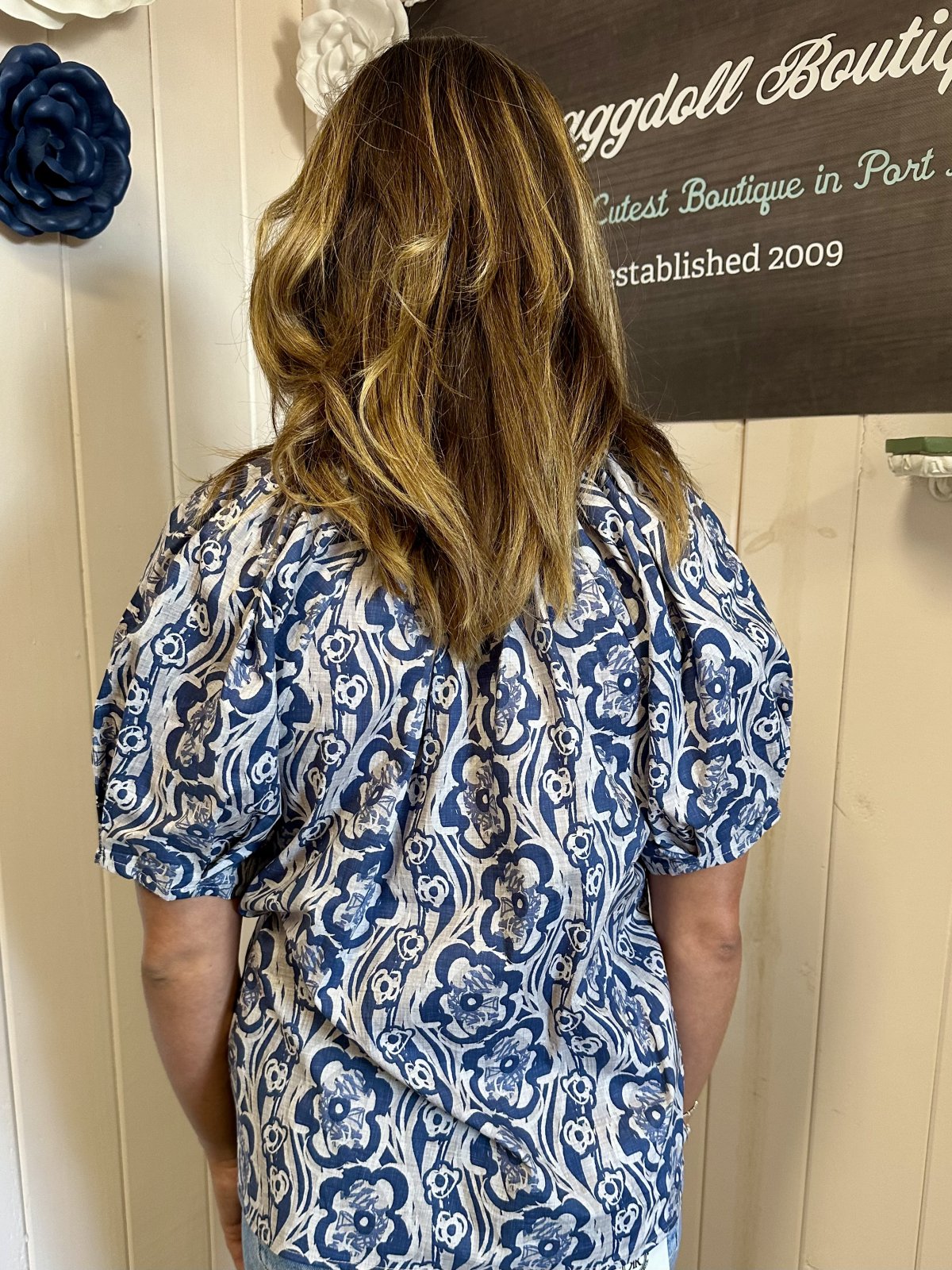 Midnight blue floral pleated top with puff sleeves, perfect for coastal boutique clothing and beach dresses for all occasions.