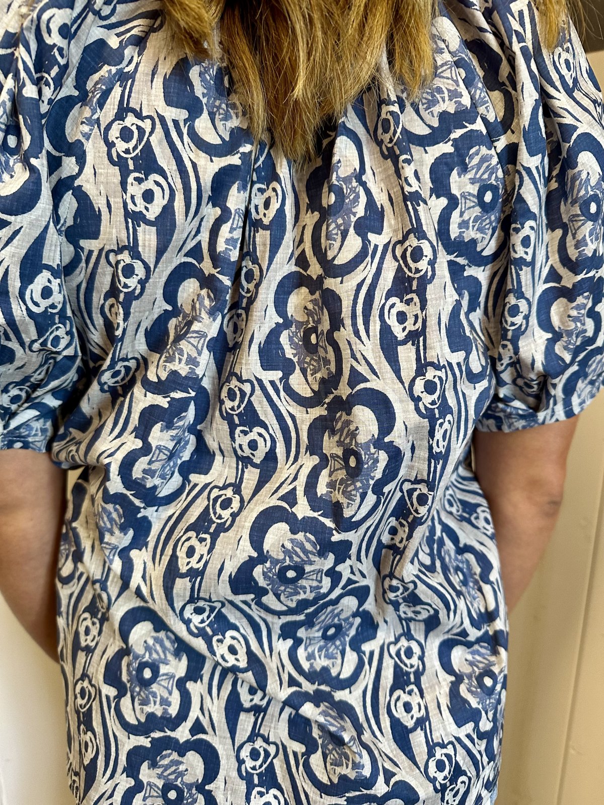 Midnight blue floral pleated top with puff sleeves, ideal for coastal boutique clothing and tropical vacation dresses.