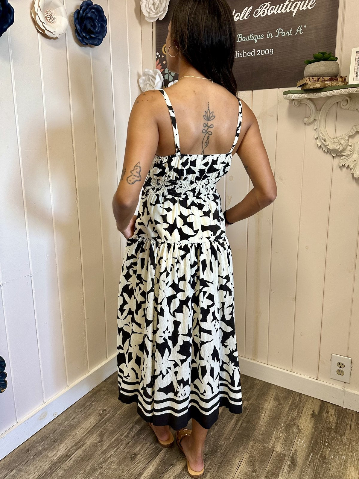 Back view of Louisa Dress in black and white floral print, perfect for coastal boutique clothing and tropical vacations.