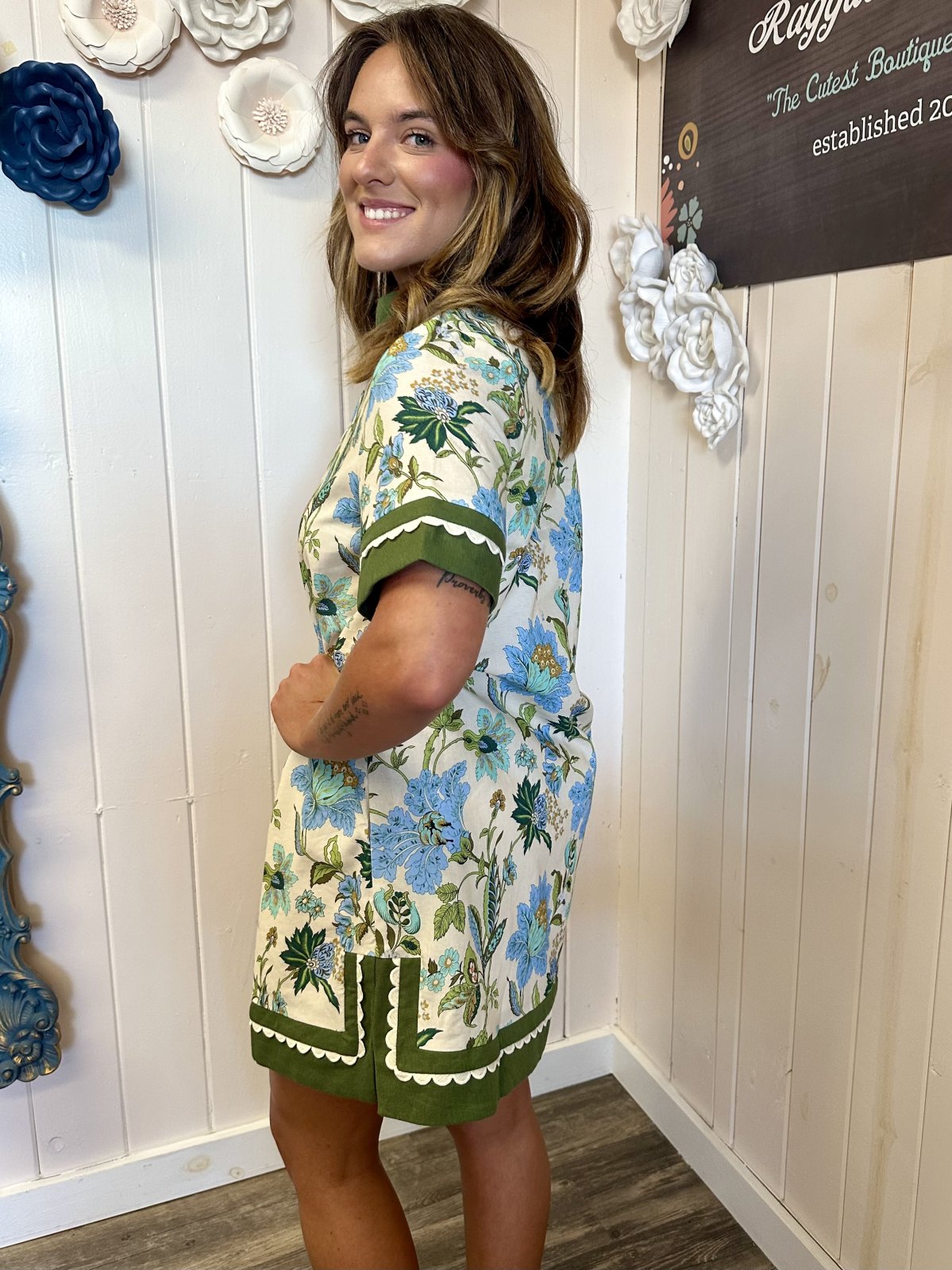 Model showcases the Harper Dress, a floral print mini dress perfect for coastal boutique clothing and tropical vacations.