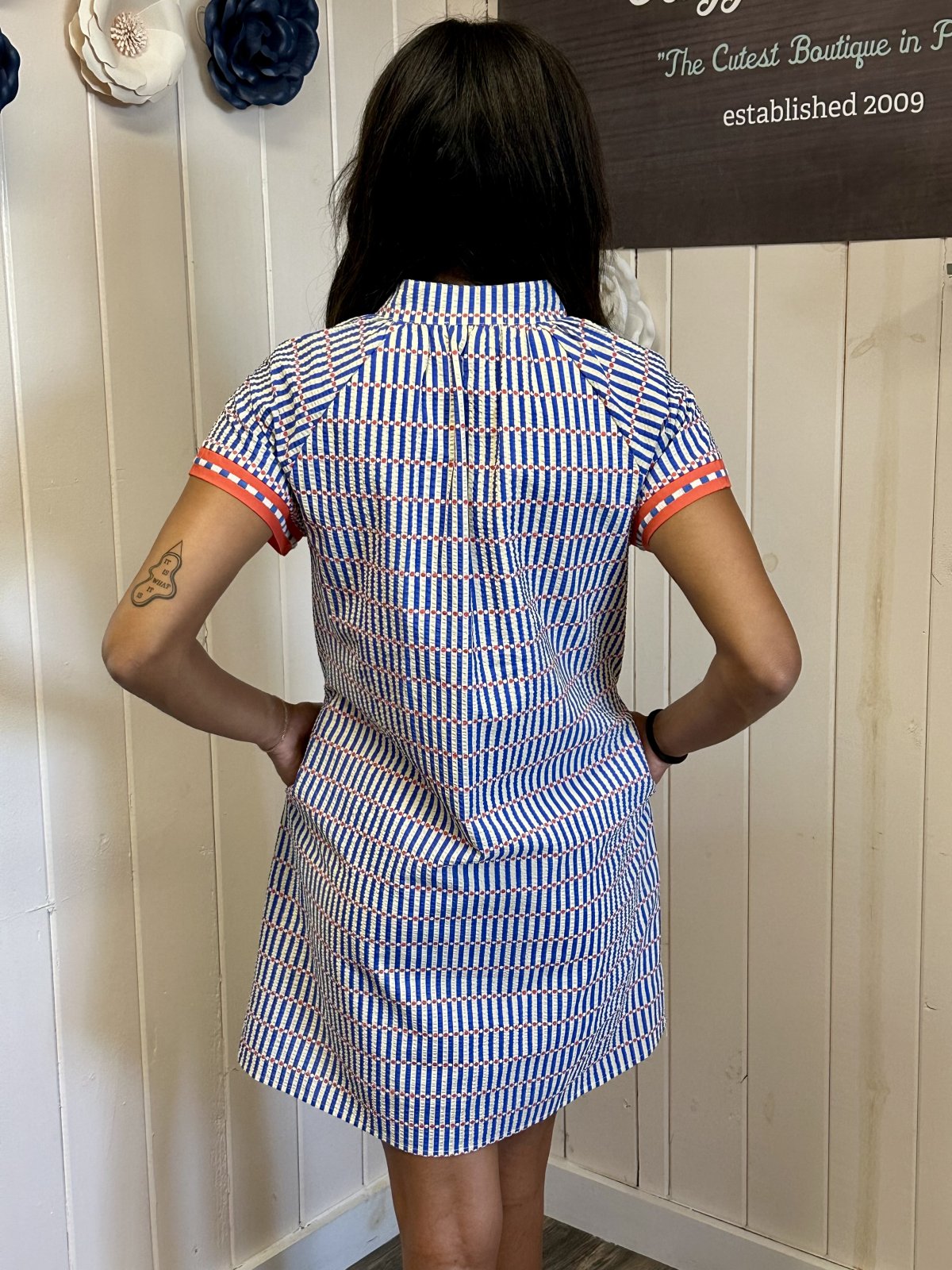 Back view of a striped Aubrey Dress from a coastal boutique, perfect for beach outings and summer gatherings.