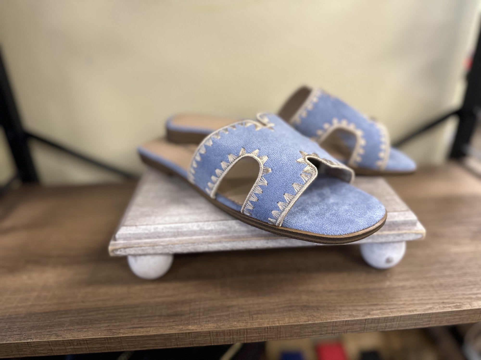Melly Blue Shoe: Stylish tan suede cut-out slip-on sandals, perfect for coastal boutique clothing and tropical vacation dresses.