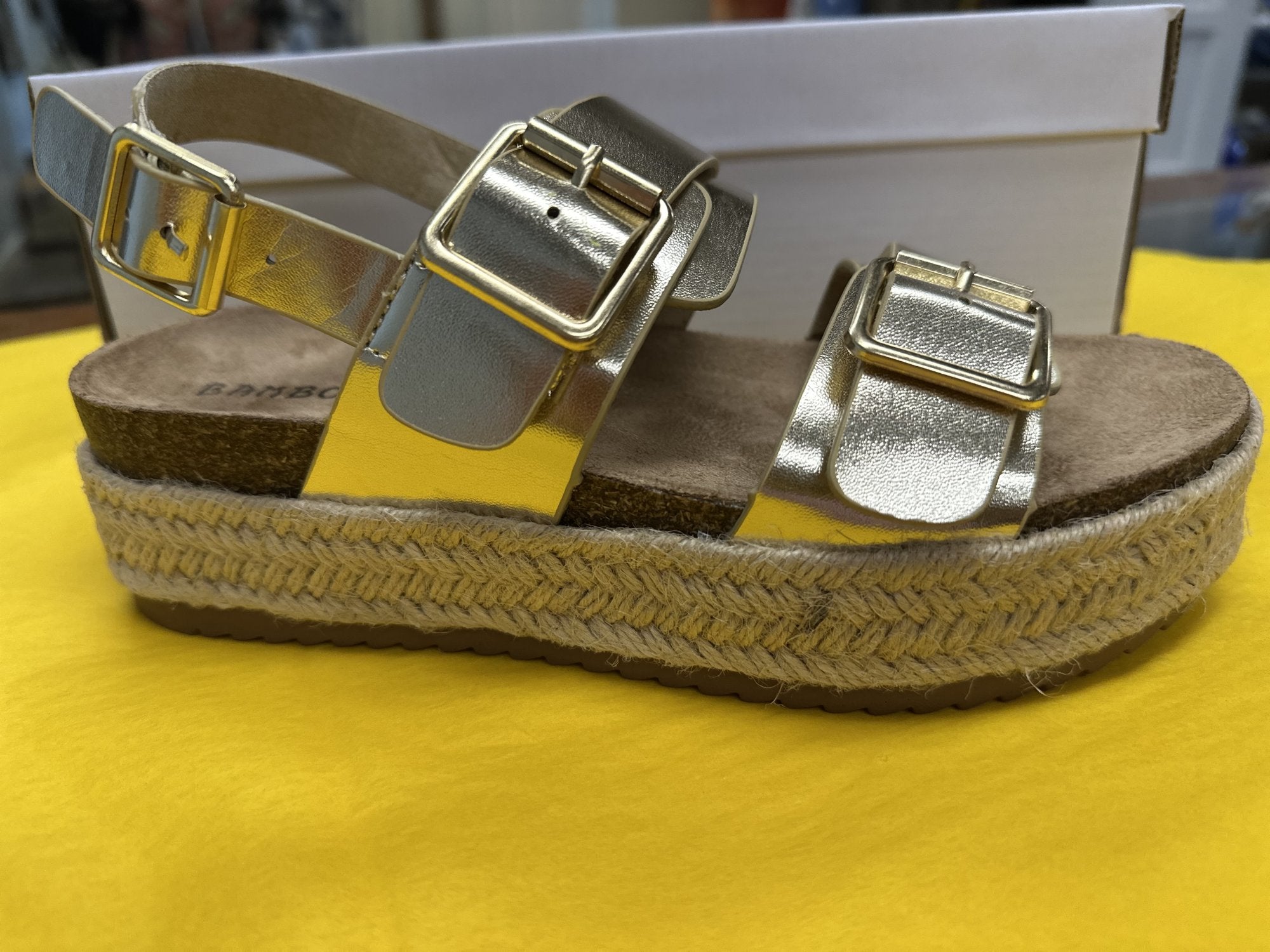 Gold metallic double buckle espadrille sandals with cork sole, perfect for stylish summer outfits from a Port Aransas boutique.