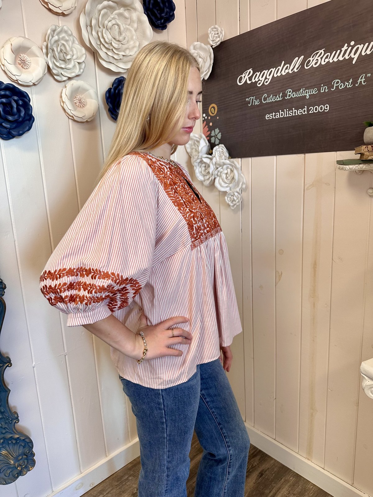 Model wearing the Jessa Top from Raggdoll Boutique, showcasing trendy coastal style in Port Aransas.