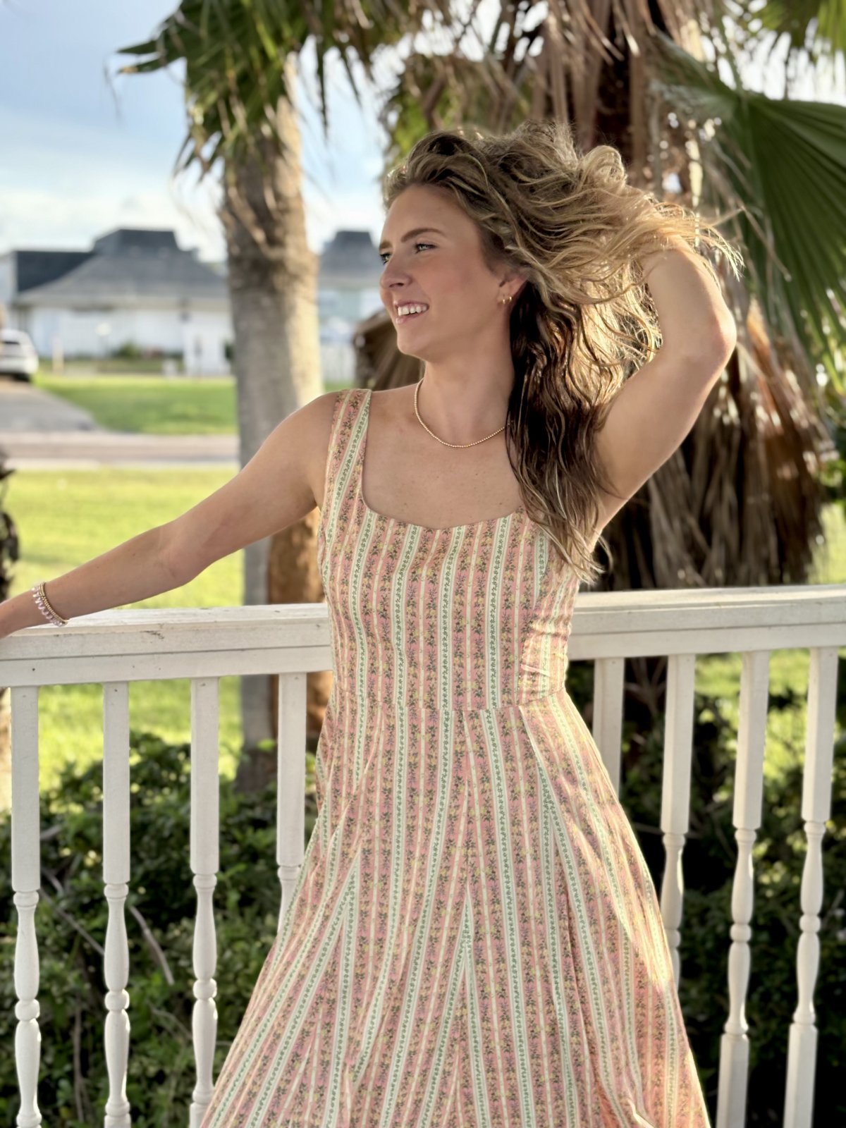 Light coral floral fit and flare midi dress for women, perfect for spring and summer, from a Port Aransas boutique.