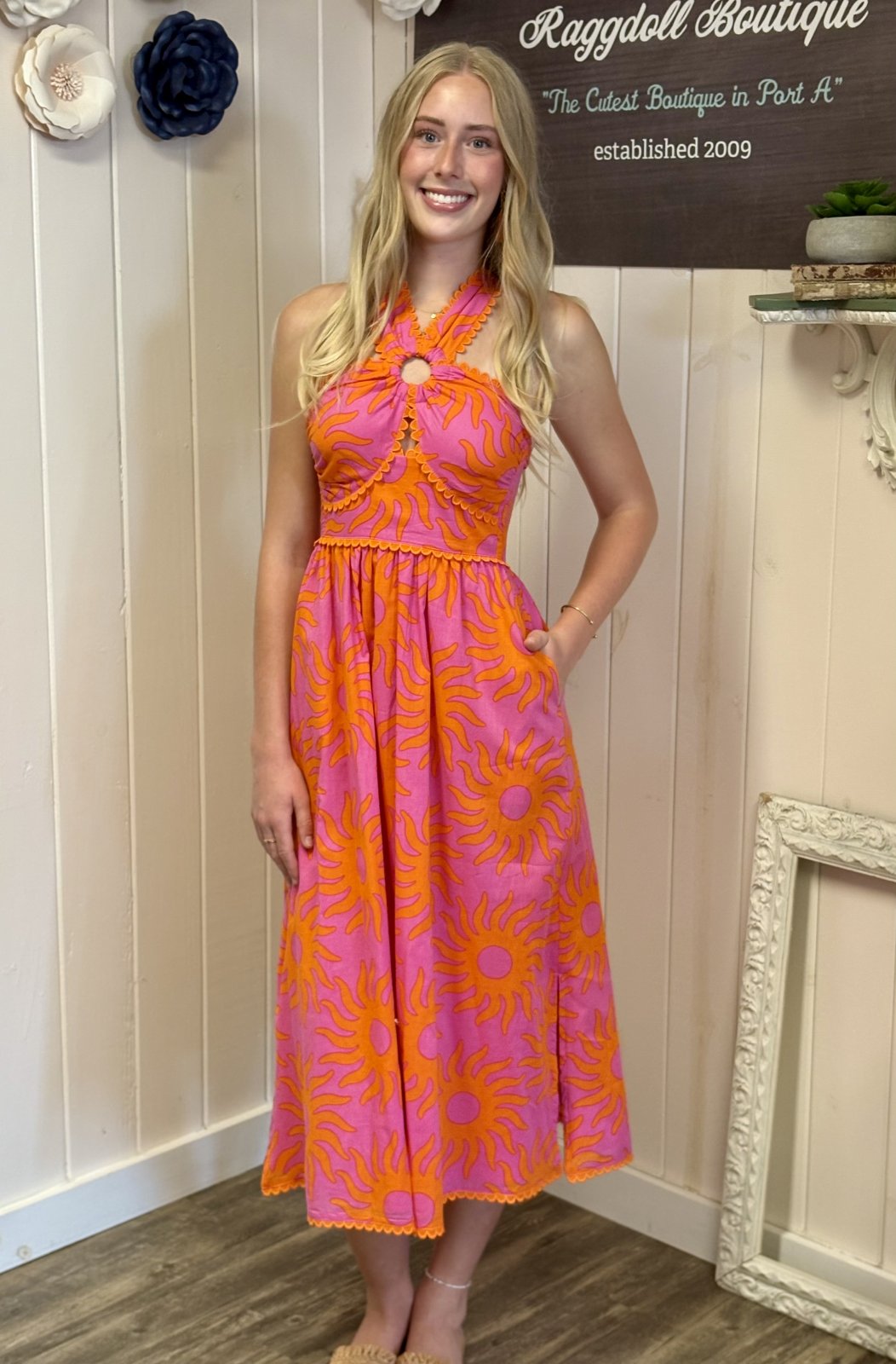 Mara Dress at Raggdoll Boutique: vibrant orange and pink midi with ric rac trim, perfect for tropical vacations and summer events.