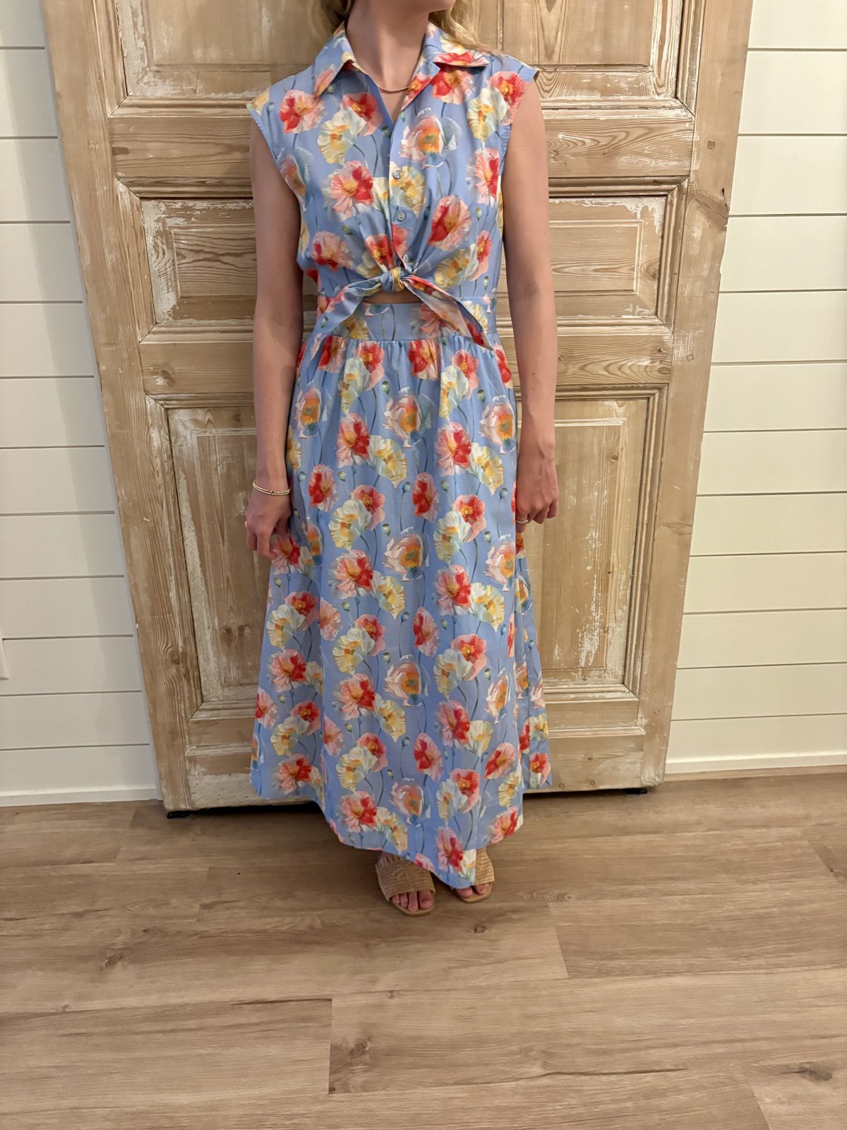 Light blue floral print sleeveless midi dress from coastal boutique clothing, perfect for summer and tropical vacations.