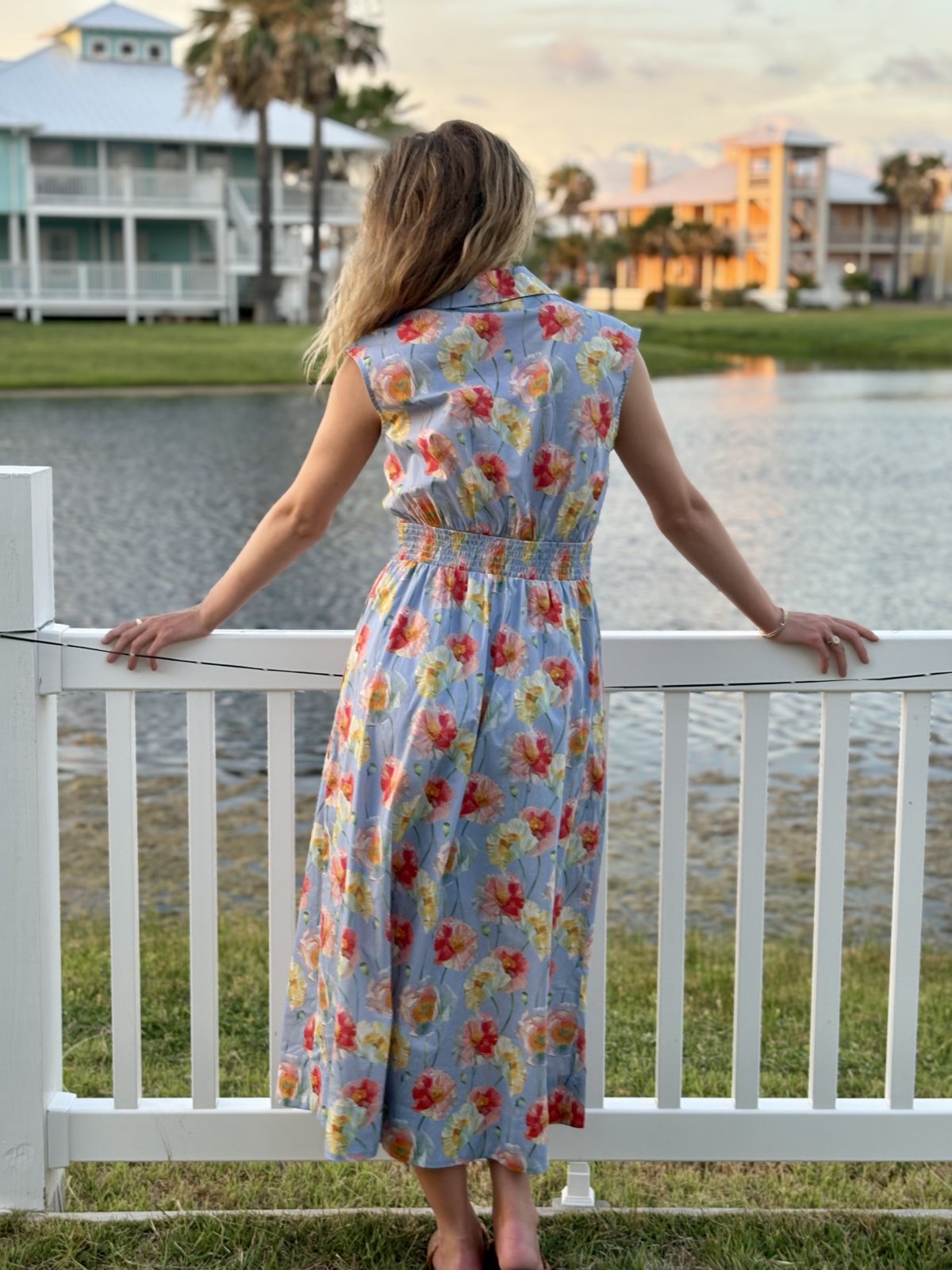 Light blue floral print sleeveless midi dress from a coastal boutique, perfect for tropical vacations and women's fashion.