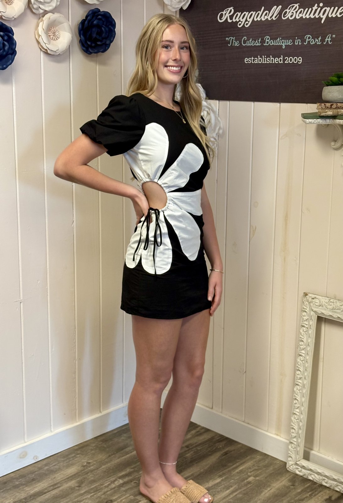 Model in black and white floral mini dress from a Port Aransas boutique, perfect for beach outings or spring dates.