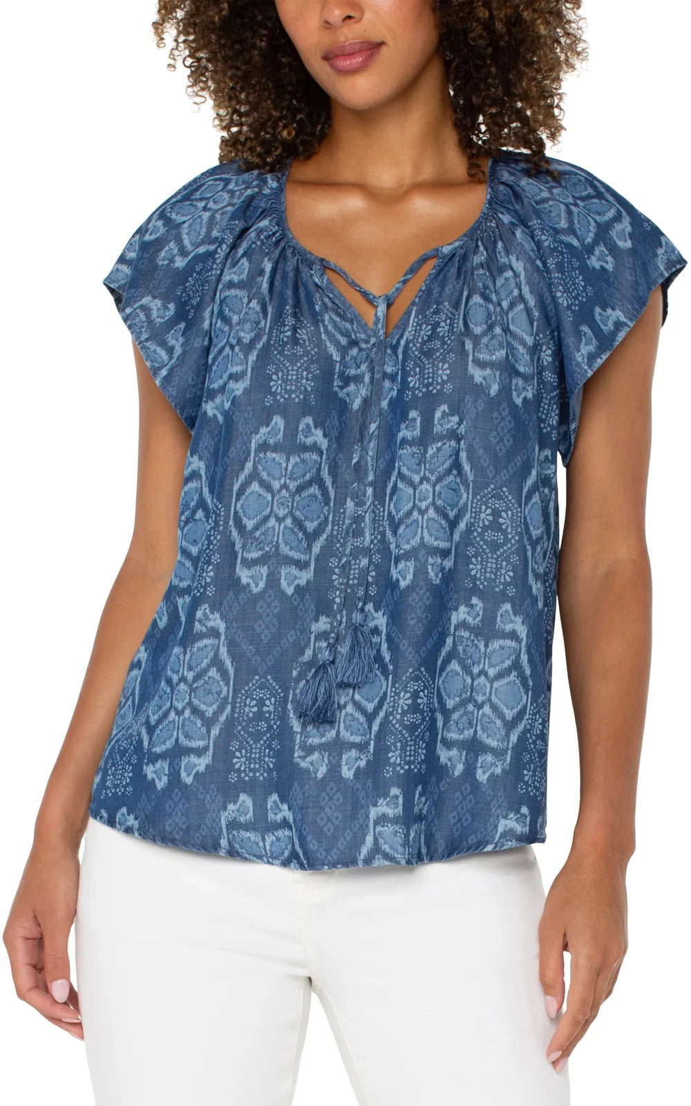 Chambray tribal printed top with flutter sleeves, front tie and tassels, perfect for coastal boutique clothing.