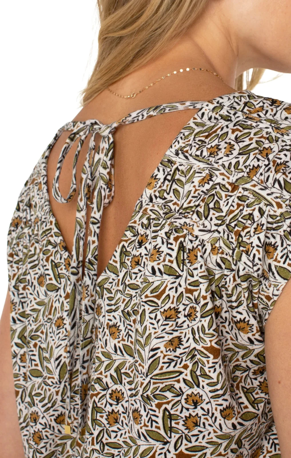 Olive print tie-back top featuring shirred short sleeves and a stylish back design, perfect for coastal boutique clothing.