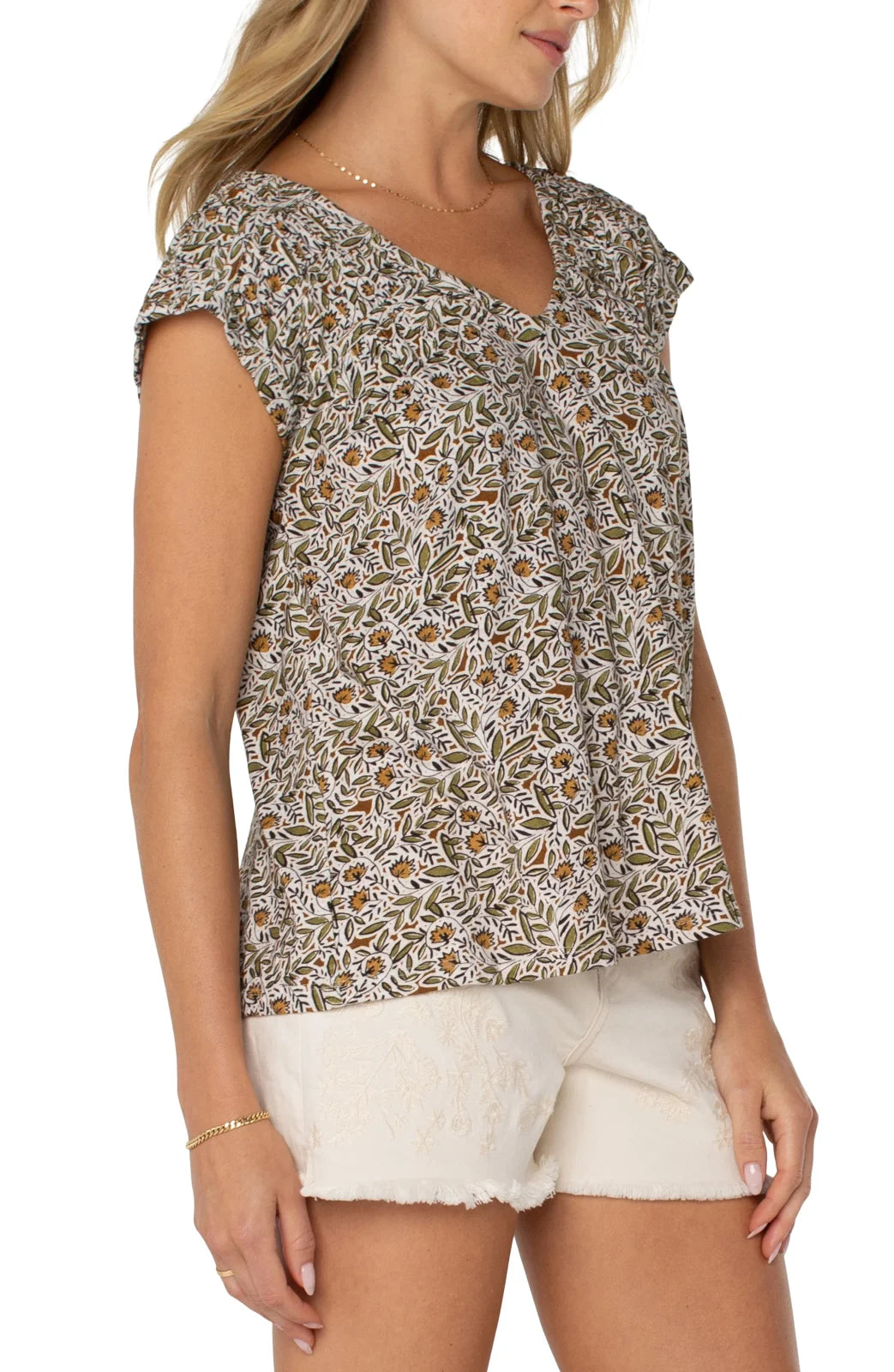 Olive print tie-back top with shirred short sleeves, perfect for coastal boutique clothing style.
