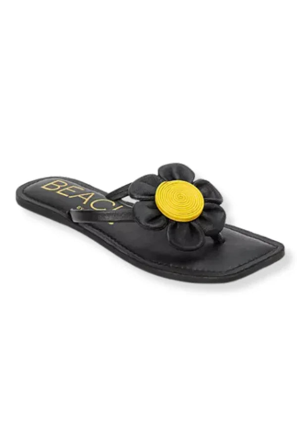 Stylish black flip flop sandals with yellow flower applique, ideal for coastal boutique clothing and summer vacation outfits.