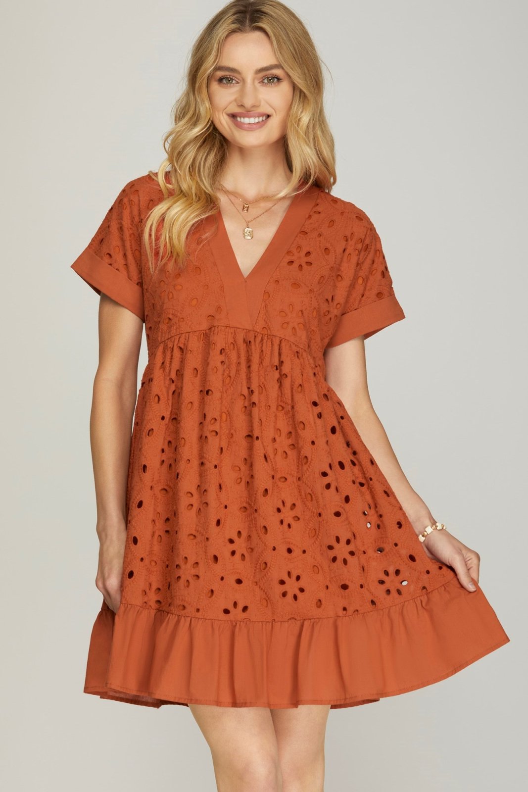 Rust-colored embroidered drop shoulder dress from a coastal boutique, perfect for tropical vacations and casual outings.