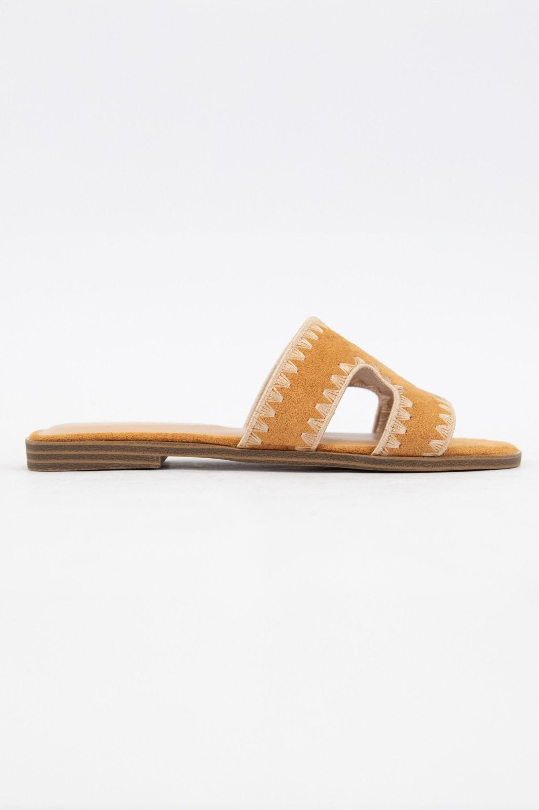 Melly Tan Shoe from Raggdoll Boutique, a chic tan suede slip-on sandal with cut-out design, perfect for summer outfits in Texas.