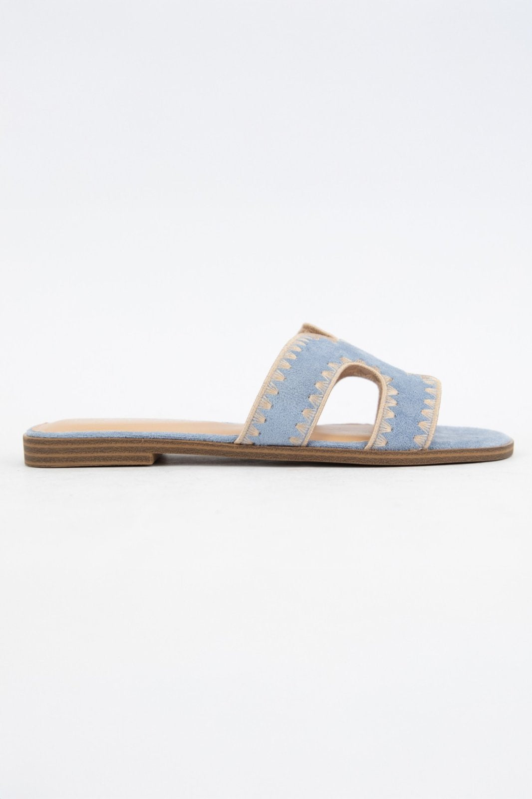 Melly Blue Shoe: Tan suede cut-out slip-on sandals with stitched edge, perfect for Port Aransas boutique style and tropical vacations.