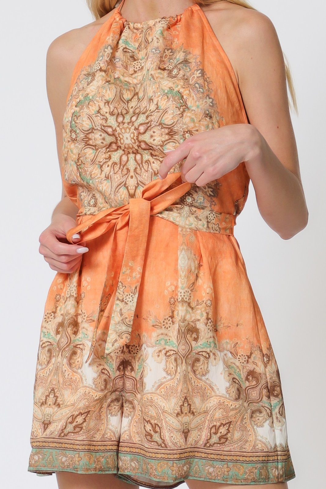 Light apricot halter romper featuring a self-tie belt, perfect for coastal boutique clothing and summer outings.