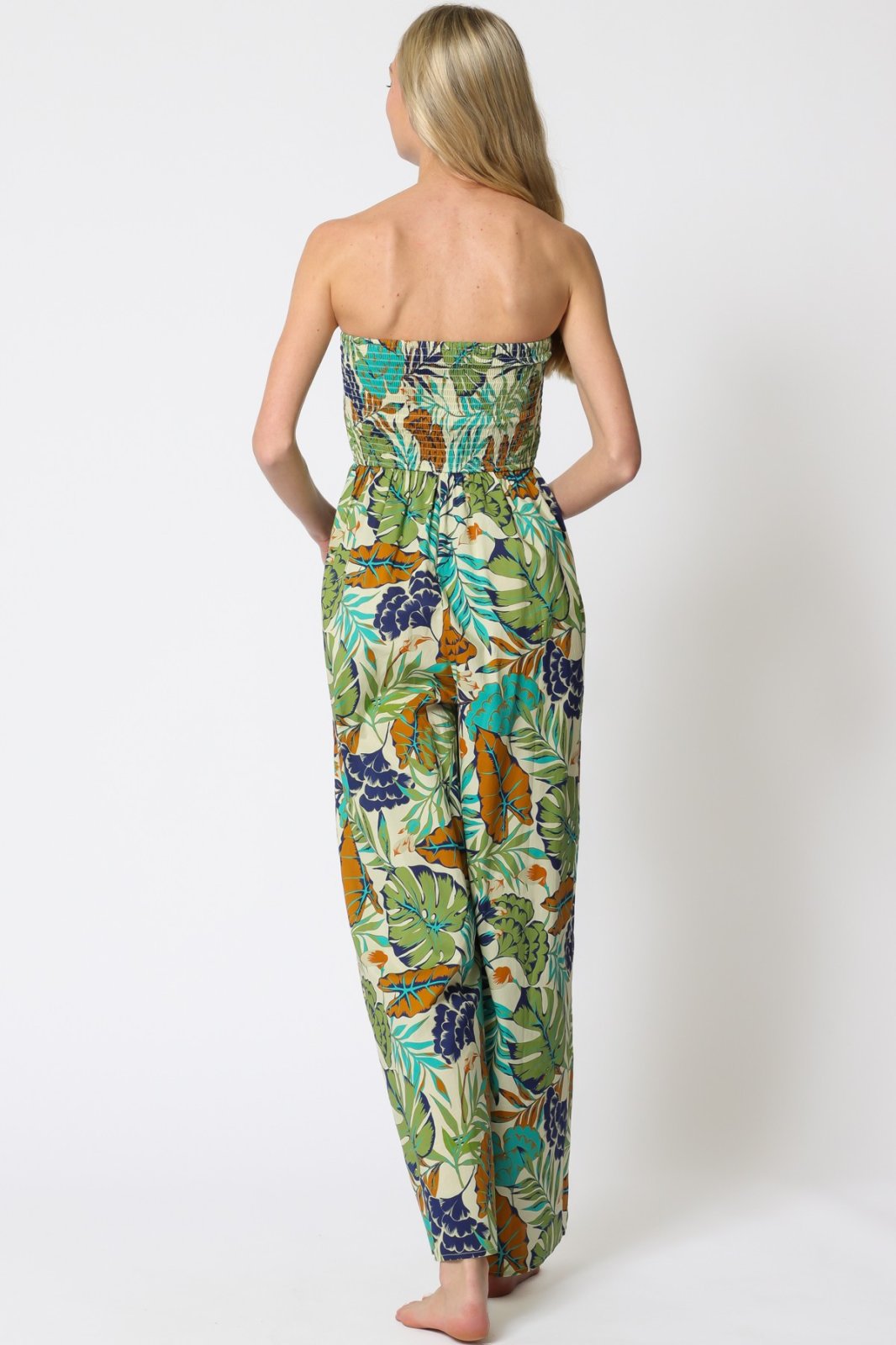 Back view of a strapless floral jumpsuit ideal for tropical vacations, from a coastal boutique clothing collection.