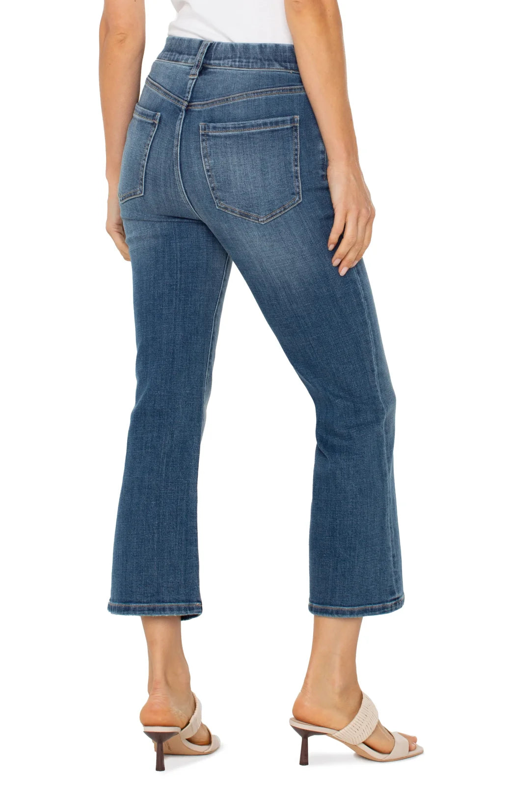 Stylish Liverpool Gia Crop Flare Jeans showcased at coastal boutique, perfect for curvy plus size fashion and tropical vacations.