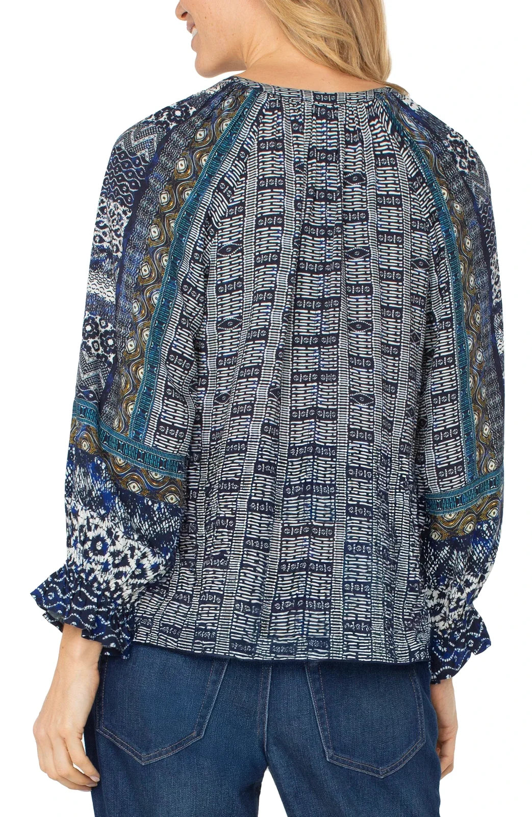 Stylish blue shibori blouse from Liverpool with ruffled cuffs, perfect for coastal boutique clothing and tropical vacation styles.