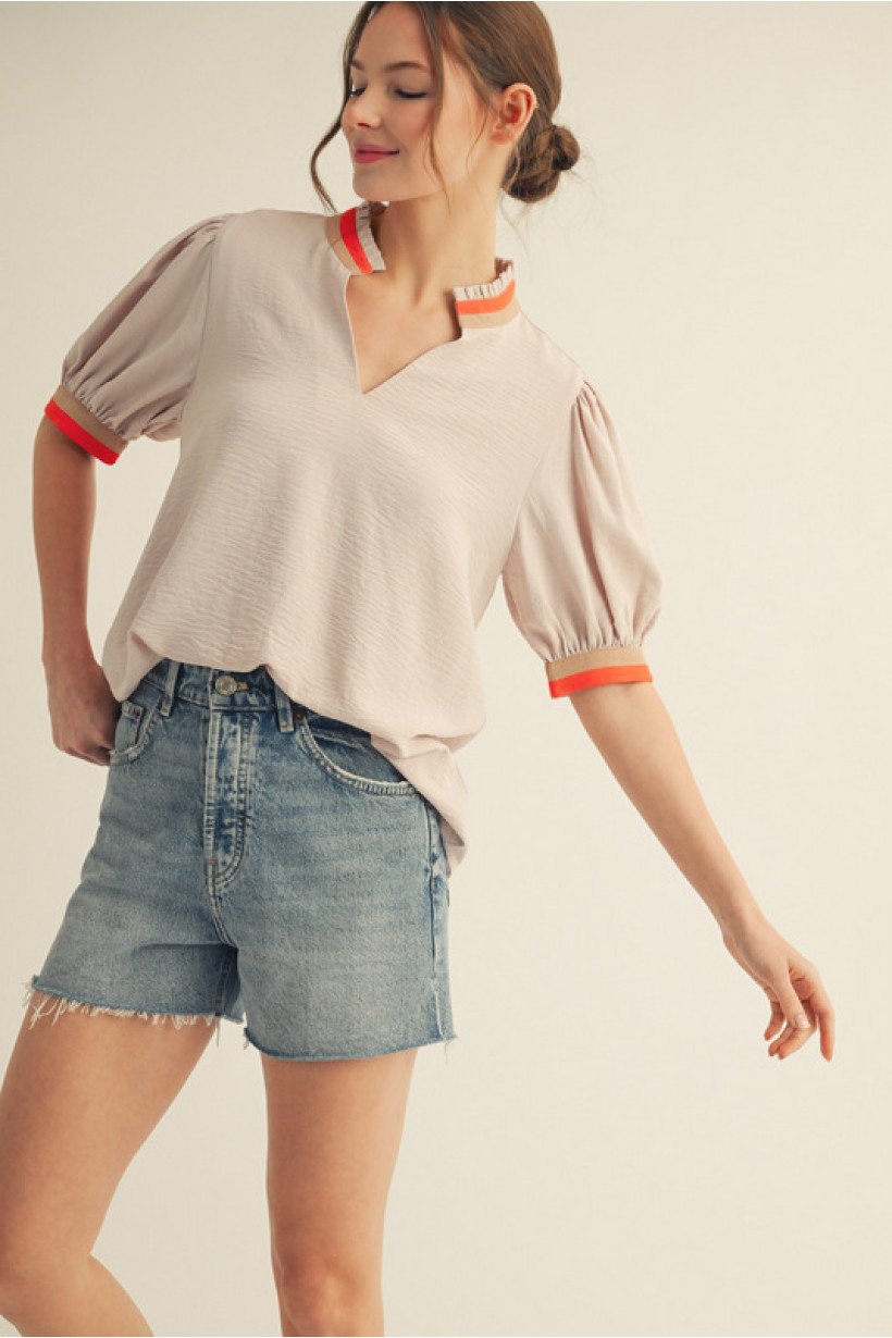 Stylish tan half-sleeve top with orange trim, perfect for coastal boutique clothing and trendy casual outfits.