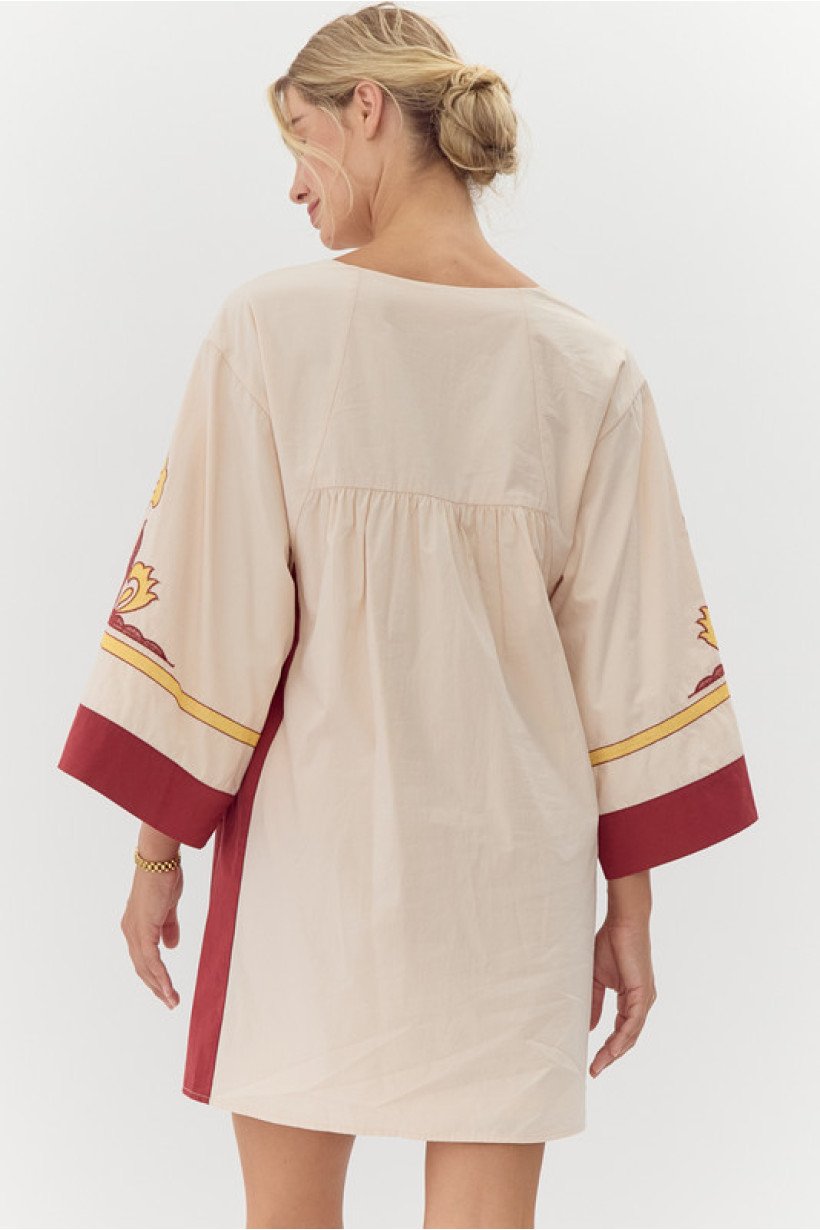 Model wearing Talia Dress, 100% cotton with stylish embroidery, ideal for coastal boutique clothing and tropical vacations.