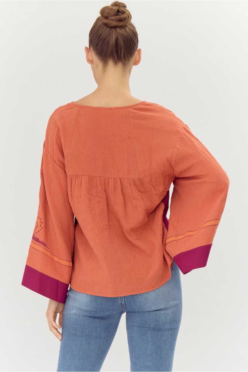 Back view of a rust and wine embroidered top, 100% cotton, ideal for coastal boutique clothing and stylish women's fashion.