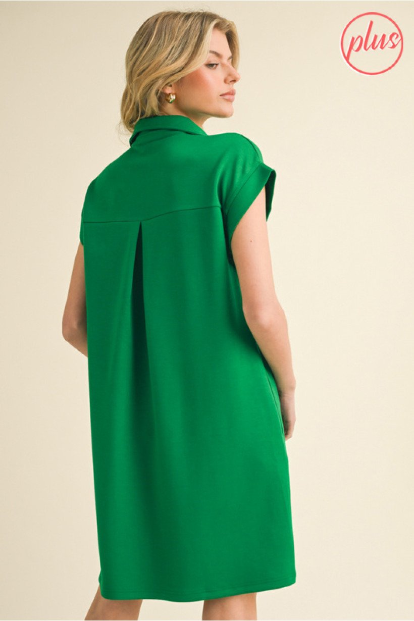 Plus-size green dress featuring a collared neckline and back pleats, perfect for coastal boutique clothing and tropical vacations.