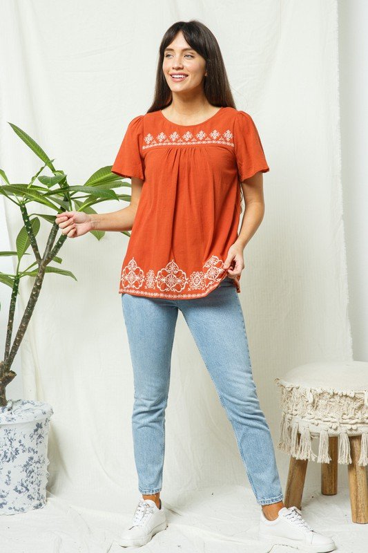 RUST EMBROIDERED TOP with contrasting lace, short sleeves, pleated hem, styled for vacation wardrobe boutique.