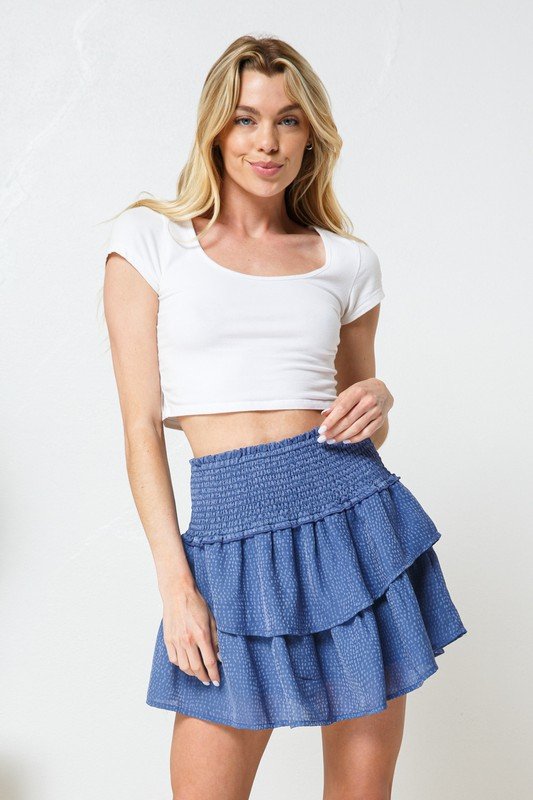 Model wearing a BLUE SATIN DOT SKORT paired with a white top, showcasing trendy coastal style from Raggdoll Boutique.