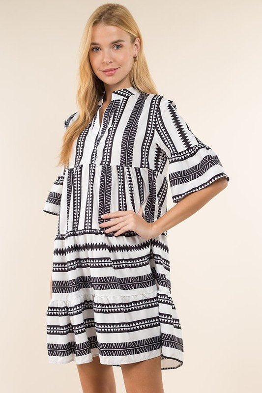 TRIBAL STRIPED BLACK AND WHITE DRESS from Raggdoll Boutique, featuring notch neck, bell sleeves, and ruffle hem skirt.