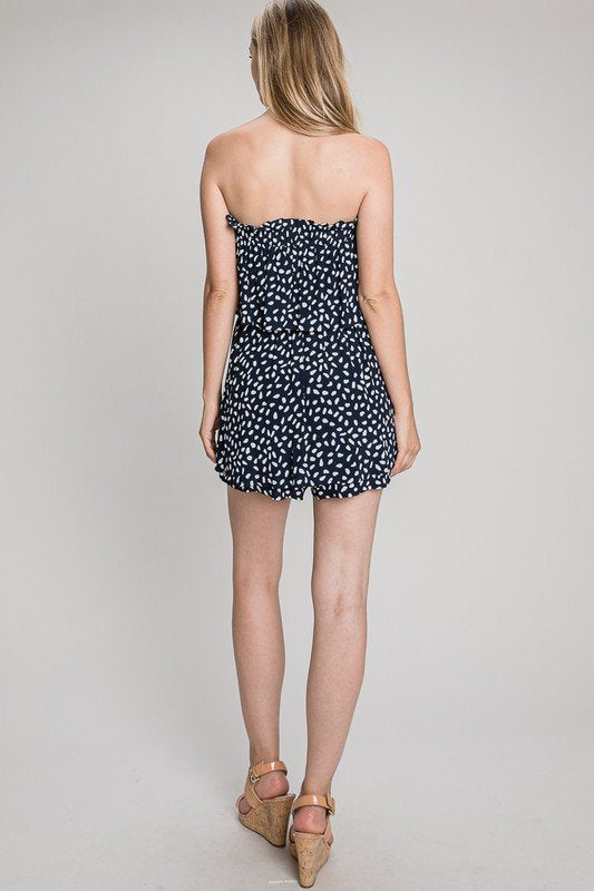 NAVY AND WHITE OVERLAY FLOWY ROMPER displayed from the back, perfect for summer outfits Texas and trendy coastal style.