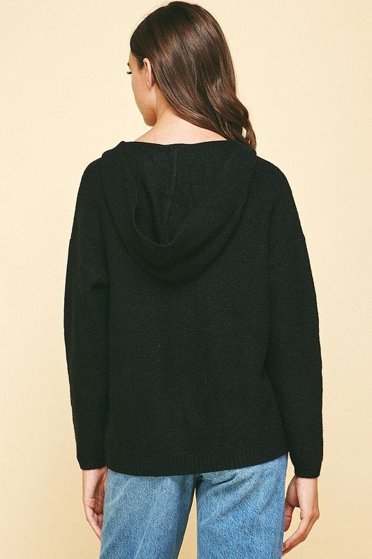 Back view of a woman wearing a BLACK KNIT HOODIE from Raggdoll Boutique, showcasing its cozy fit and stylish design.
