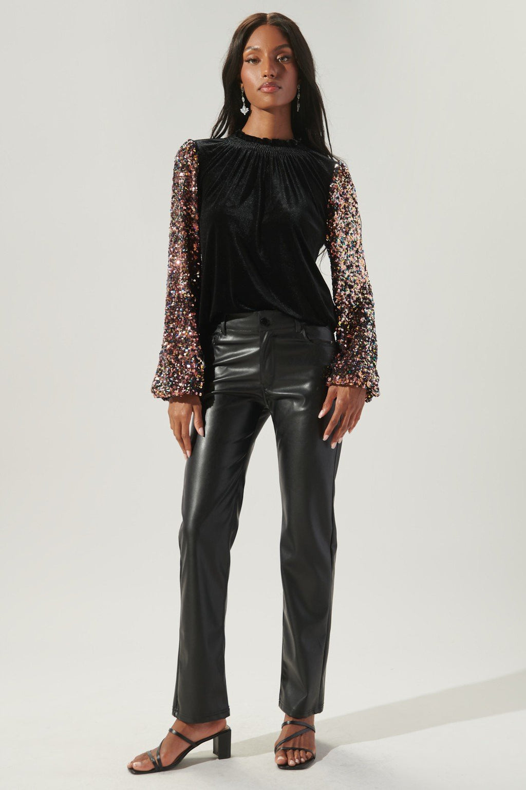 Black Velvet top with Sequin Detail Sleeves paired with stylish black leather pants, perfect for coastal fashion.