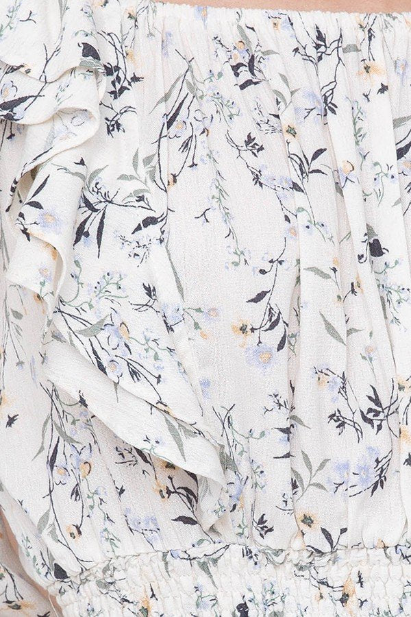 Floral print detail of Mila Top, featuring ruffles and elastic waist, perfect for coastal boutique clothing and summer style.